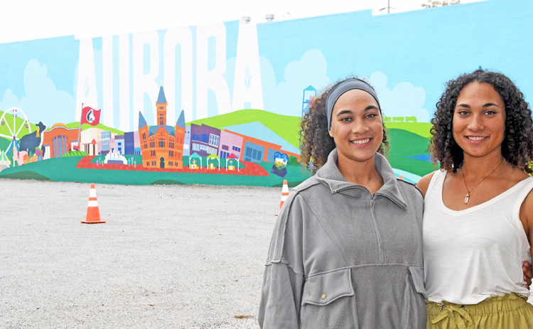 Mural artists Bristol, left, and Brianna Lewis pose for a photo in front of their finished artwork.