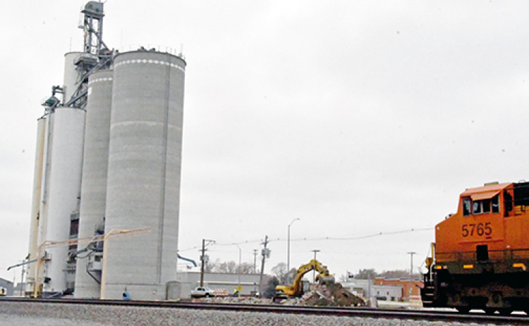 A track hoe begins dirt work on the site of the new CVA whole corn cleaning plant in Hampton. The facility will be attached to the existing silos , above, along Highway 34 and will be dedicated completely to food grade corn.