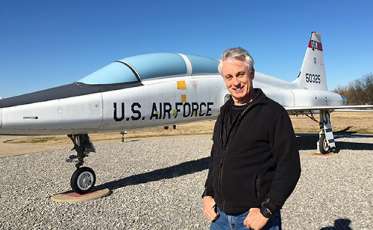 Sen. Loren Lippincott stands in front of a T38 fighter pilot training jet on display. During his days as a U.S. Air Force Top Gun he flew T38s in pilot training and fighter lead in training.