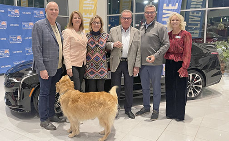Pictured from left at Thursday’s 25 Keys of Christmas car giveway are campaign chairmen Mark and Renee Miller, Kim and Tom Dinsdale, car winner Terry Pfeifer, and United Way President Karen Rathke.