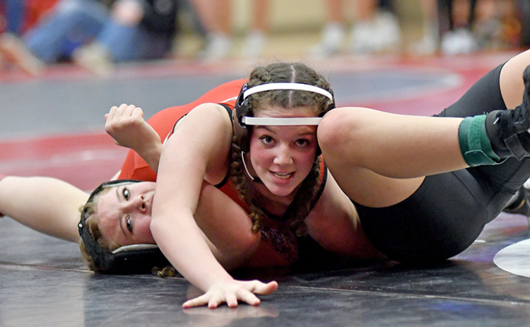 Di Maria Leininger looks for the camera while collecting a pinfall victory during Aurora’s home Invite Thursday. The Husky girls won the team title, edging Grand Island Northwest by 15 points.