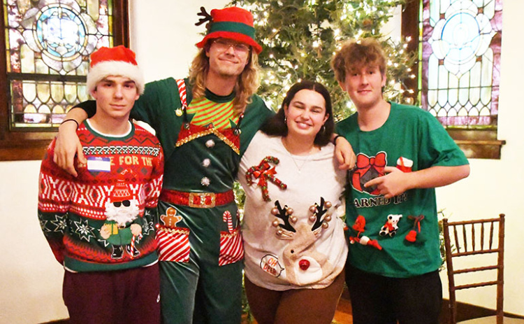 Displaying their ugly Christmas sweaters for Education First’s Christmas party were from left: Noham Borie (France), Jitse Valkenburg (Netherlands), Emma Heckmann (Germany) and Nils Lendi (Switzerland).