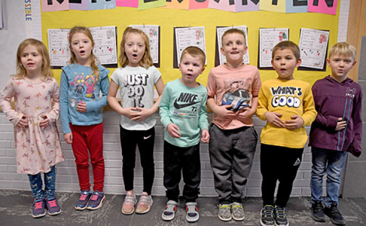 The seven members of Hampton’s kindergarten class demonstrate Santa’s trademark “HO, HO, HO” laugh as they stand in front of their Christmas bulletin board. From left are Grace Winfield, Josie Herman, Anniston Arnett, Carter Klute, Bodee Conard, Eelix De La Cruz and Axel Fisher.
