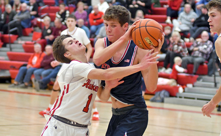 Canon Allen tries to poke the ball away to save an extra offensive possession during Aurora’s 44-42 loss to Adams Central Thursday.