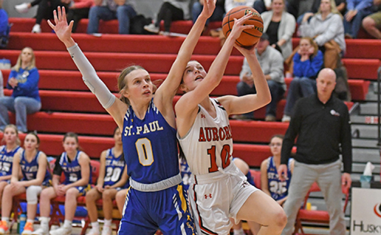 Aurora sophomore Kenna Merrihew powers up for two against St. Paul’s Gracie Mudloff. Merrihew scored 10 points in the win.
