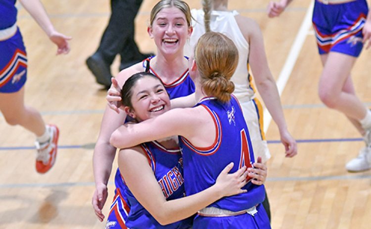 HPC’s girls basketball team took time to celebrate a 32-30 come-from-behind victory over Shelby-Rising City in the CRC quarterfinals Monday. Coach Megan Bruce comes to join the group hug started by Courtney Carlstrom (left), Gahvi Lesiak (middle) and Peyton Hofmann.