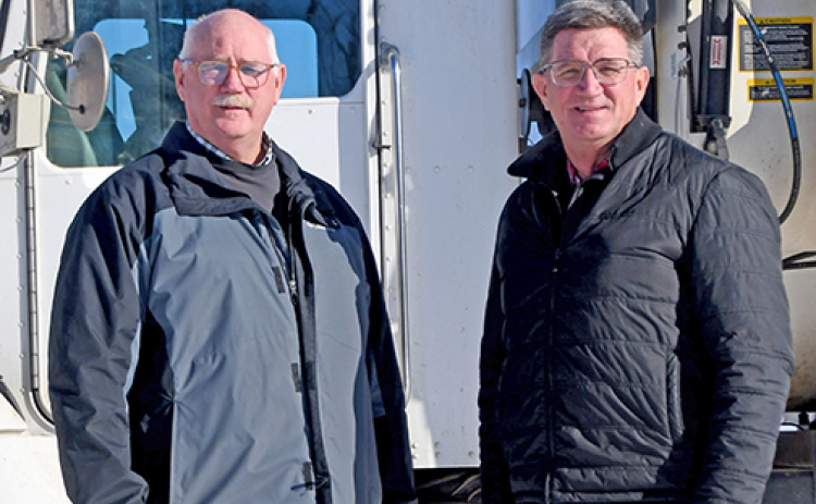 Brothers Dean, left, and Mark Klute stand by one of the two feeding trucks they use in their Triple K Cattle Company cattle feeding operation northeast of Hampton. The company is being honored this week by the York-Hamilton County Cattlemen at their 75th annual banquet in York.