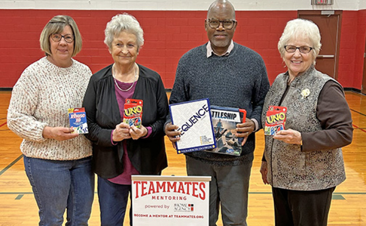 Polk United Methodist Church members brought new games and cornhole sets for mentors and their mentees to play with. From left, Audrey Samuelson, Sharon Johnson, Pastor Duncan Ibuuri and Karen Stevens.