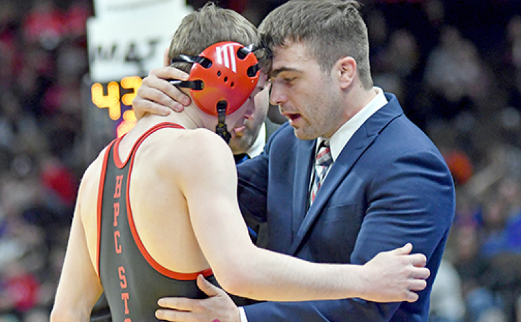 Aurora senior Lance Russell receives a motivational message from his coach, Martin Phillips after suffering a shoulder injury early in his finals match and had injury time run out on his chances.