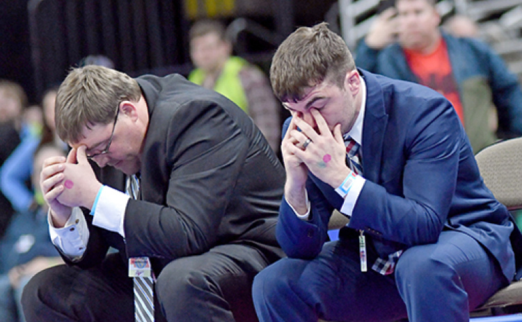 HPC coaches Fred Church (left) and Martin Phillips react as time runs out on Wyatt Urkoski’s finals match, finishing second and seeing his undefeated campaign end with a loss.