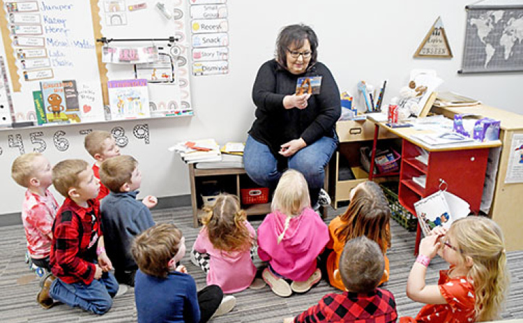 Giltner preschool teacher Amy Wilson shows her students a postcard received from Arizona as part of the ‘Valentines Across the Country’ project she started.