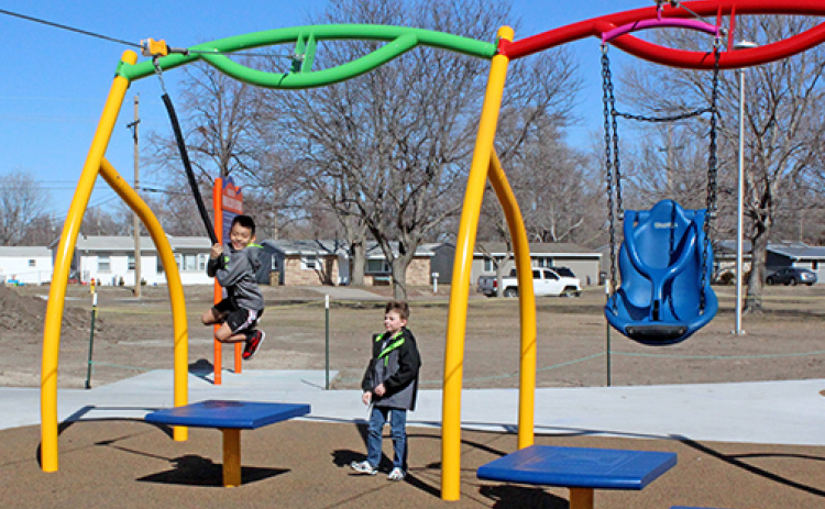 Side by side ziplines at the Pirnie inclusive playground in Grand Island feature the traditional disc on the left for able-bodied kids to straddle, while the zipline on the left features a swing seat to hold children with disabilities.