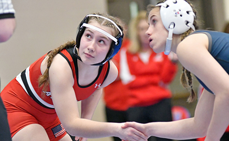 Paityn Wyatt shakes hands with her opponent prior to the start of the match. Wyatt was unable to reach the top four spots at Saturday’s 3A subdistrict, ending her season with a 23-12 record.