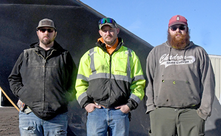 Three employees of the Hamilton County Highway Department stand in front of one of the huge v-plows that were used to open 960 miles of gravel county roads during last month’s storms. From left are Beau Johnson, Asst. Supt. B.J. Frauendorfer and Dylan Christenson.