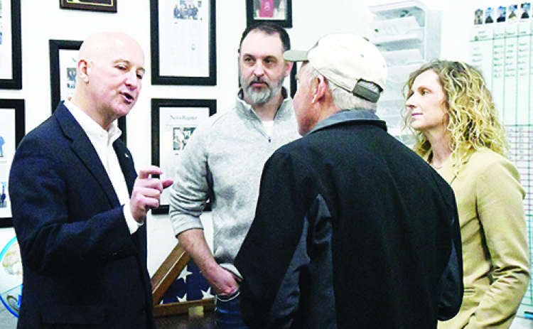 U.S. Sen. Pete Ricketts talks with local residents during his “Meet with Pete” visit to Aurora on Monday. Pictured from left are Mike Bergen, Francis McDonald and Kelsey Bergen.
