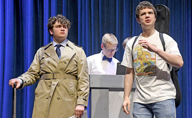Sam Elge, left, plays Owen Casey, a private investigator who is not amused by aspiring musician Nelson Henry, played by student actor Atticus Miller, right. At center is a ticket holder played by Derek Wilson.