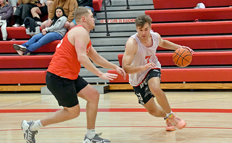 The Class of 2022/23’s Preston Ramaekers dribbles past 2018’s Ian Boerkircher during the Aurora alumni tournament final Sunday as 22/23 ended the winning run of 2018, 43-22.