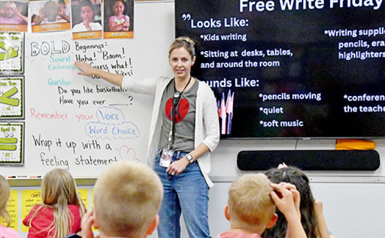 Aurora first grade teacher Sara Luzum begins her Free Write Friday session encouraging her students to write about a subject that comes from their heart.