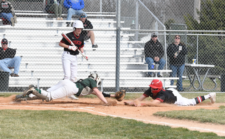 Jace Dorsey goes full extension at the plate in what became a loud collision during Aurora’s 18-7 win over Maxwell St. Pats Friday.