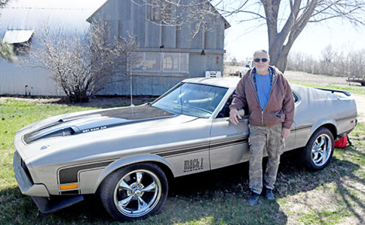 Glenn Nielsen stands next to his 1971 Mustang that took six years for him and his friends to fully restore.