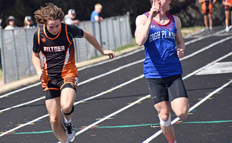 HPC’s Gavin Morris looks to his left to see his winning 100 meter dash time, finishing just ahead of Giltner’s Blaydon White (left).