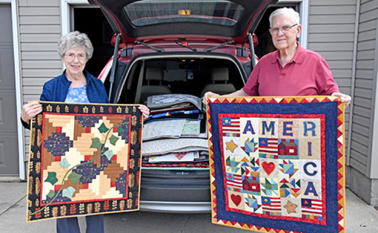 Lorna and Larry Epp show two of the 80 quilts that they recently delivered to a museum in Hamilton, Mo. The Aurora woman is the co-founder of the Nimble Thimble Quilt Guild and has created more than 400 quilts in her lifetime.