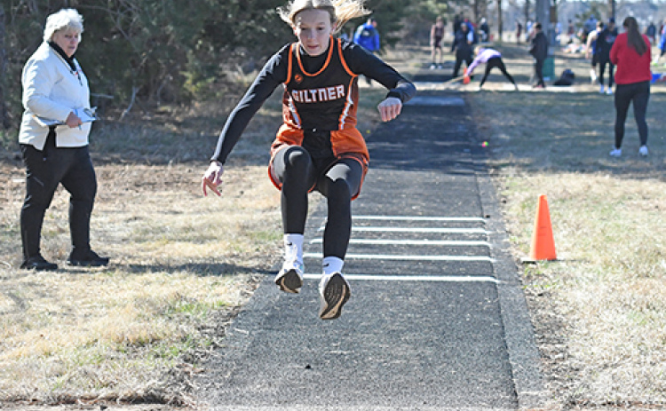 With Coach Nancy Lockmon looking on as the triple jump event coordinator, Giltner freshman Jayci Buettner flies through the air at the Osceola Invite Thursday.