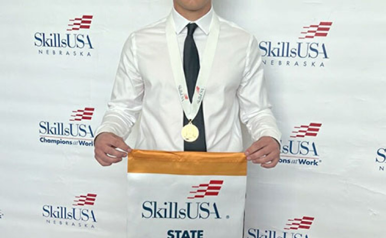 Connor Smith displays the State Champion banner he won at the SkillsUSA collegiate competition in Grand Island on April 13. He is now preparing for the national competition in Atlanta, Ga. in June.