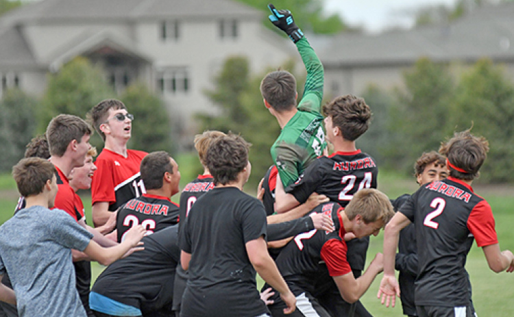 Aurora celebrates after Rylan Bartek (one finger up) stopped a pair of York penalty kicks to give the Huskies a 4-3 win over the Dukes Saturday in the B-7 subdistrict opener.