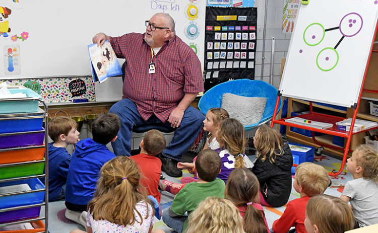 During his visit to Jayden Eby’s kindergarten class as a mystery reader, Pastor Bill Stearn read ‘Beloved’ by Jordan Feliz to the students with his granddaughter, Nora (center) sitting close to him.