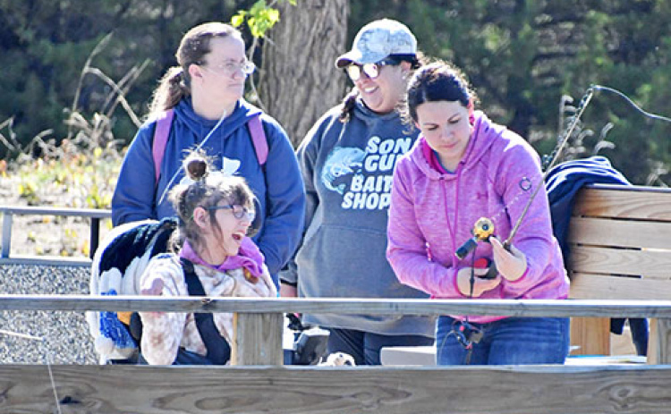 Delaney Schaeffer (front left) had a blast fishing with volunteer Rachel Sundberg at Opportune Acres’ Outdoor Expo on May 4 at Bader Park.