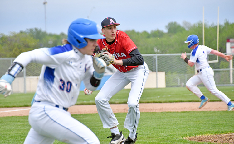 Aurora pitcher Booker Scheierman fields a bunt and sets up for a toss over to first base for the out.