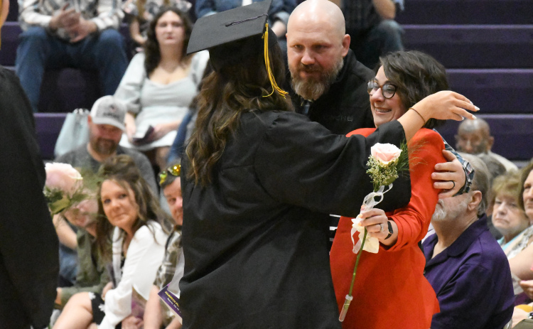Hampton senior Shae Kingery shares a hug with her parents Beau and Denise.