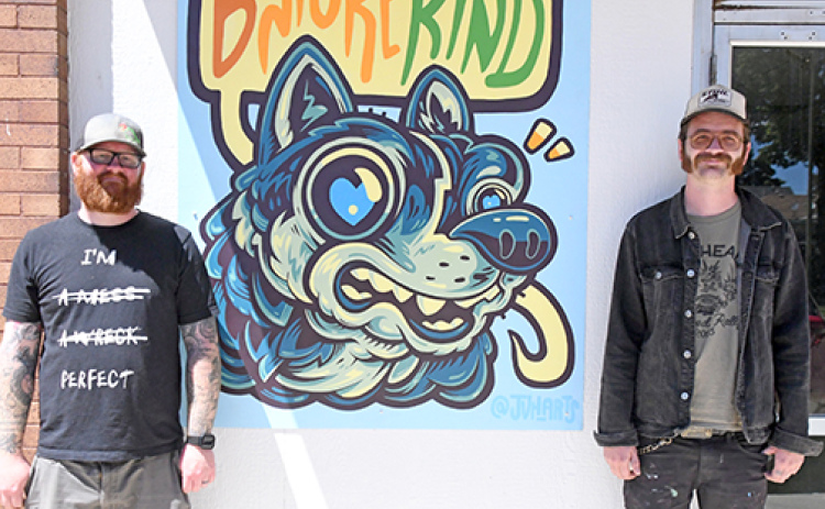A new mural for the Hamilton County Youth Center was bolted to the side of the building Friday, May 24. Pictured from left are Youth Center Executive Director Paul Johnson and mural artist John Van Horn.