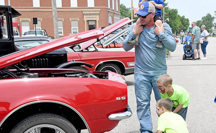 A family inspects one of the car show entries at last year's Giltner Daze.