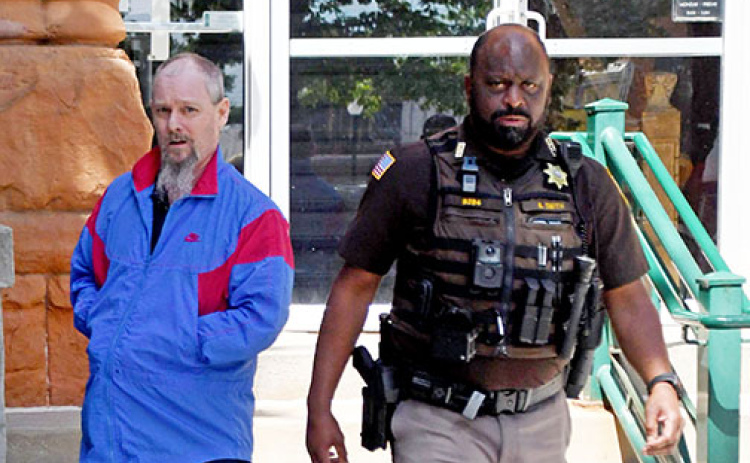 Murder defendant Jeffrey Adams leaves the Hamilton County Courthouse on Friday in the custody of Chief Deputy Aaron Smith