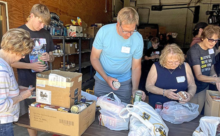 Sorting through cans donated towards Can Care-a-Van, volunteers check to make sure food isn’t expired and arranged together to be put on the shelves. Volunteers featured include from left: Sally Roblee, Graham Christenson, John Christenson, Shirely Schacht and Diana Shaffer.