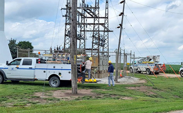 NPPD crews work at the Hampton substation near the water tower to restore electricity to village on Thursday afternoon. A broken insulator at the substation was blamed for the outage.