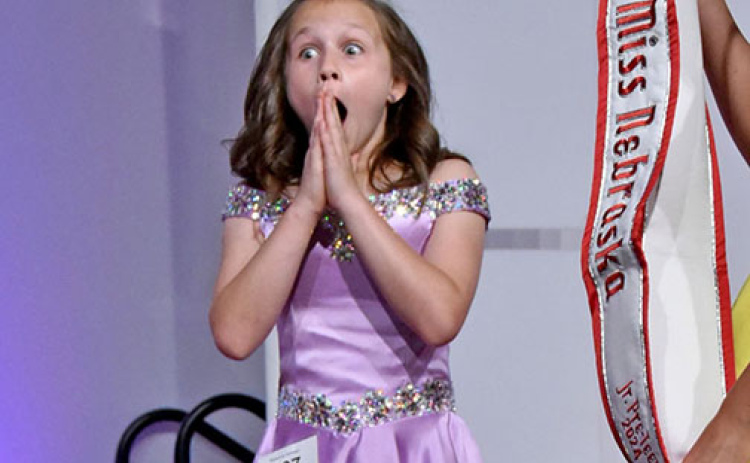 Makenna Huhman expresses shock as her name as called as the winner of the Miss Nebraska Junior Pre-Teen pageant in Omaha.