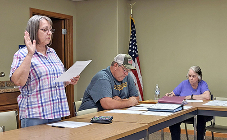 Phillips resident Dorothy Benton reads her oath of office to become the village’s newest trustee. The retired attorney replaces Jason Fry who resigned from his seat on the board and his position as fire chief at the board’s May meeting.
