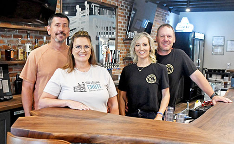Part of the ownership team of Hampton’s new Loading Chute restaurant stands at the bar of the newly remodeled establishment on 3rd Street. From left are Ryan and Tammie Bamesberger and Lisabeth and Grant Dose