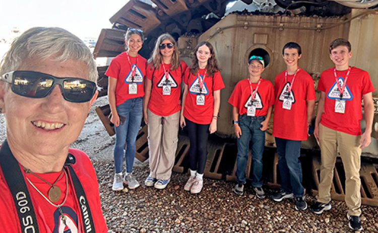 Six students were selected by the Edgerton to attend the launch of the GOES-U satellite at the Kennedy Space Center in Florida. Posing underneath the crawler, a vehcile used to move rockets to the launchpad, are from left: Edgerton educator Deb Miller, students Bridget Kavan of Broken Bow, Annika Spielberg of Minden, Joey Ballas of Aurora, Alex Taylor of Auburn,  Ryan McCalsun of Broken Bow and Shawn Morris of Aurora.