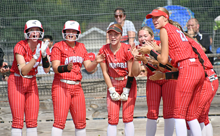 The Aurora softball team awaits Emely Gonzalez at the plate after her home run Friday against Auburn. As a team, the Huskies hit four homers in its first four games, sporting a 2-2 record in the win-loss column.