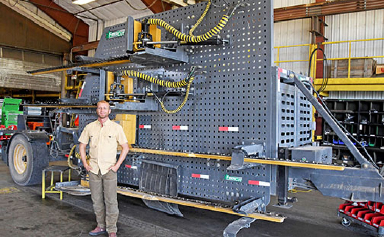 Andrew Bish stands next to one of the FiberCut Hemp Harvesters built by his company at the plant near Giltner. One of these same units was put on display at the National Mall in Washington, D.C. earlier this year as part of a national machinery show.