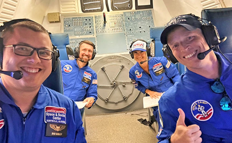 At the U.S. Space and Rocket Center, Scott Phillips and other Teachers of the Year, participated in simulated space missions. Pictured navigating the space shuttle as commander is Phillips (front right) assisted by his teammates Ryan Hardesty of Pennsylvania (front), Cory Hafer of Delaware and Aimée Couto of Rhode Island.