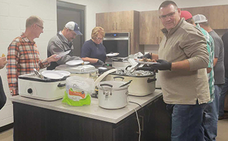 Volunteers serve meat and baked beans during last year’s Hamilton County Ministerial Alliance Cheer Fund BBQ. The third annual event is set for Sept. 29 at the fairgrounds.