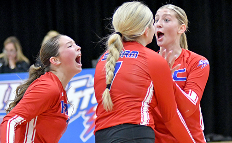 HPC seniors Rylee Ackerson (far left) Emma Brown (middle) and Courtney Carlstrom celebrate after picking up a two-set win over Riverside.