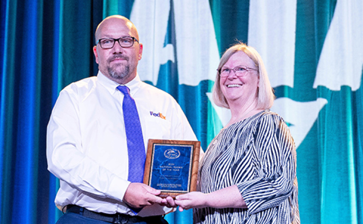 FedEx driver Todd Gimpel of Aurora is presented with a plaque proclaiming him as the National Trucking Associations’ Rookie of the Year in the twins class at the National Truck Driving Championships in Indianapolis, Ind. last month. Presenting the award is Patti Gillette, NTDC Chairman and director of safety and member services for the Nevada Trucking Association.