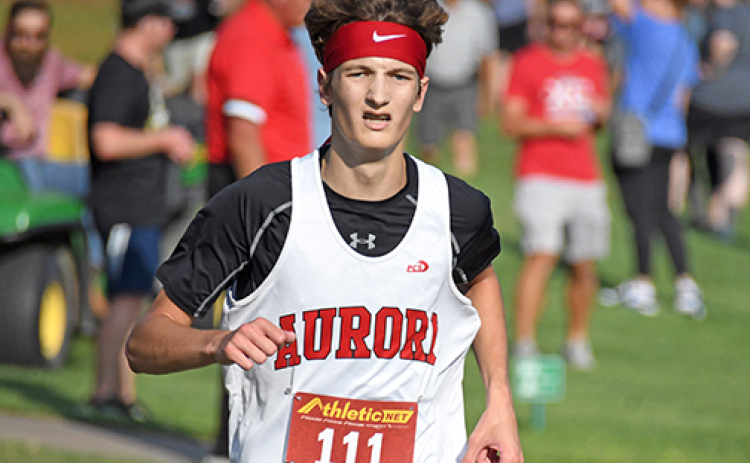 Jayden Slagle finished sixth at the Aurora Invite with a time of 17:35, one of three medalists Friday for the Huskies.