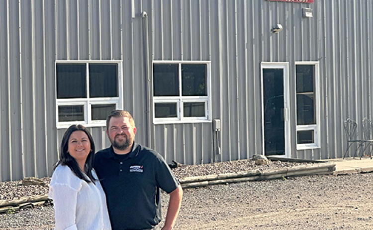 Andrew and Taylor Willis stand outside their Diamond J location on Grant Street in Aurora, after announcing that their company has been acquired by Hastings-based Cooperative Producers, Inc. The company is now operating as Diamond J Custom Services, powered by CPI.